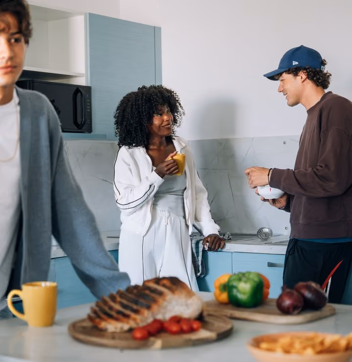 Students cooking together in a shared kitchen