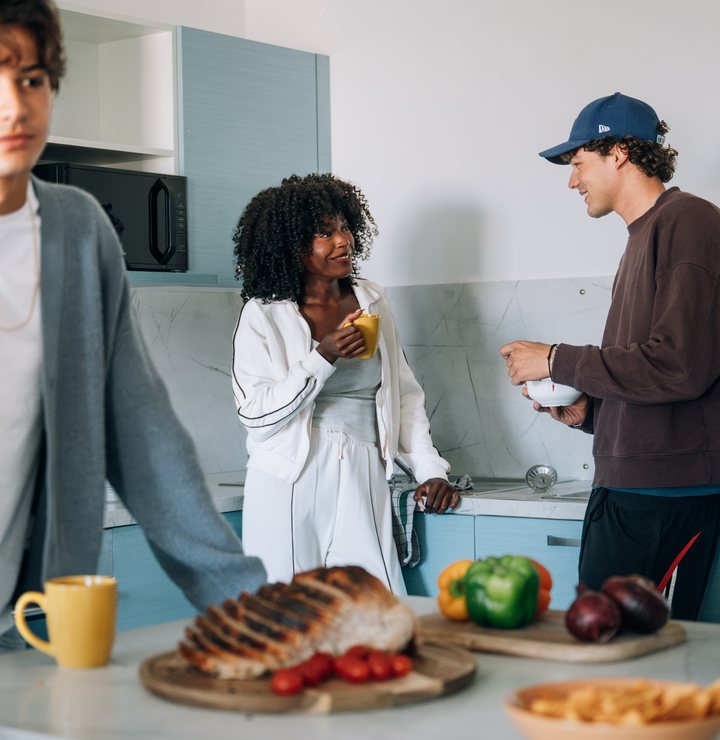 Students cooking together in a shared kitchen