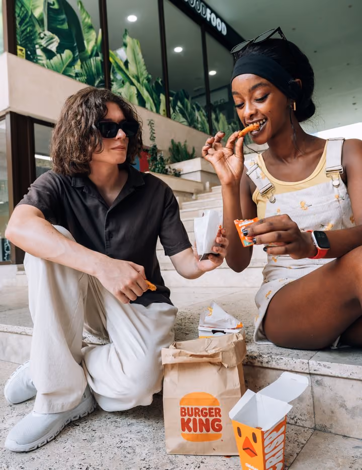 Students sitting outside eating together