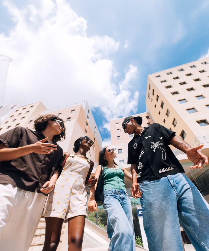 Students laughing together outside the Campus Hub buildings