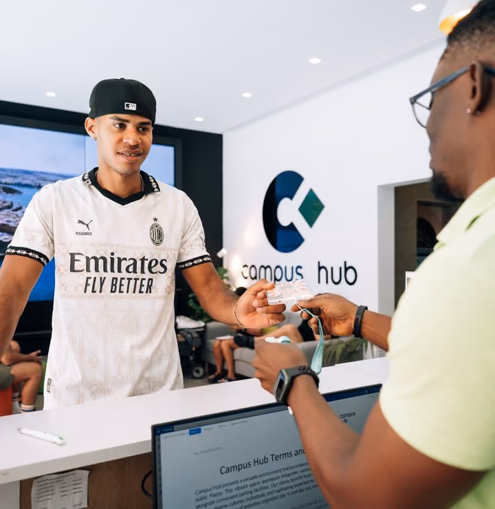 A student being welcomed at the Campus Hub reception desk