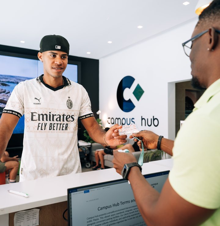 A student being welcomed at the Campus Hub reception desk