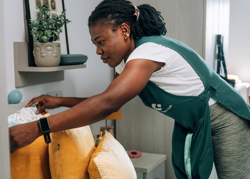 A member of the housekeeping team making up a room