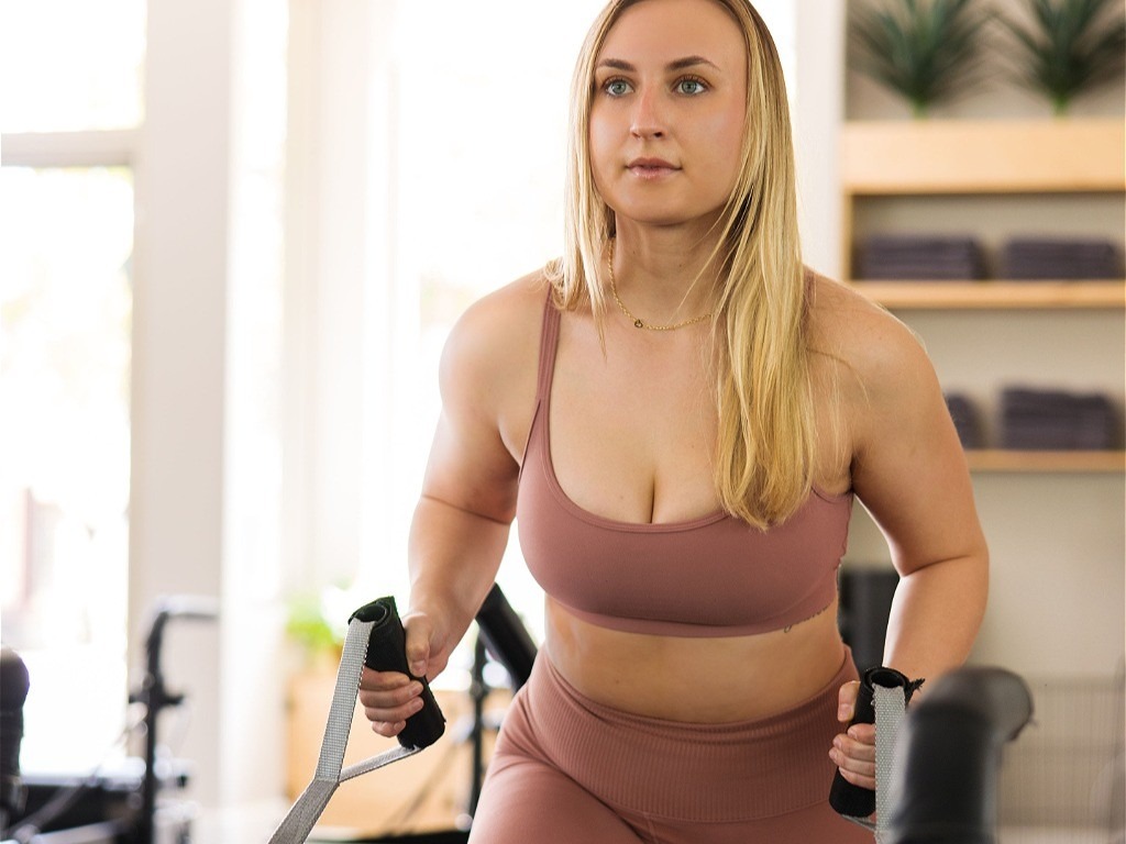 Woman using Pilates stretch grips