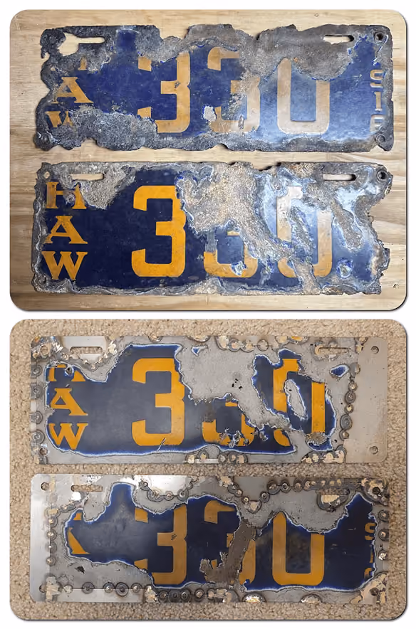 Four heavily corroded blue and yellow 330 Hawaii license plates showing rust and paint damage.