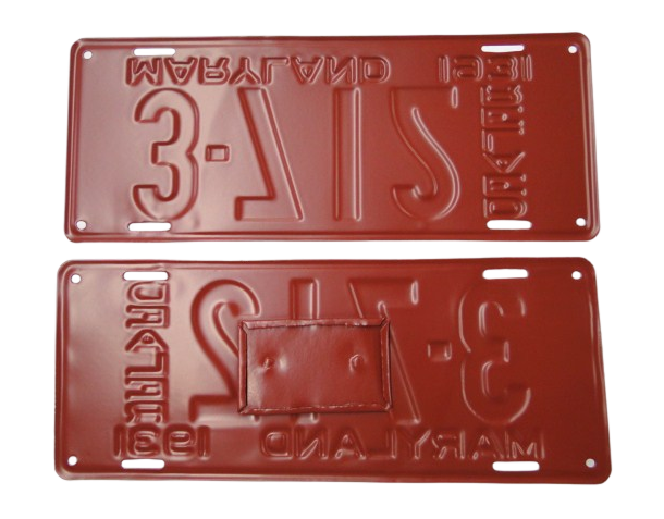 Two red embossed metal license plates with reversed text and numbers visible.