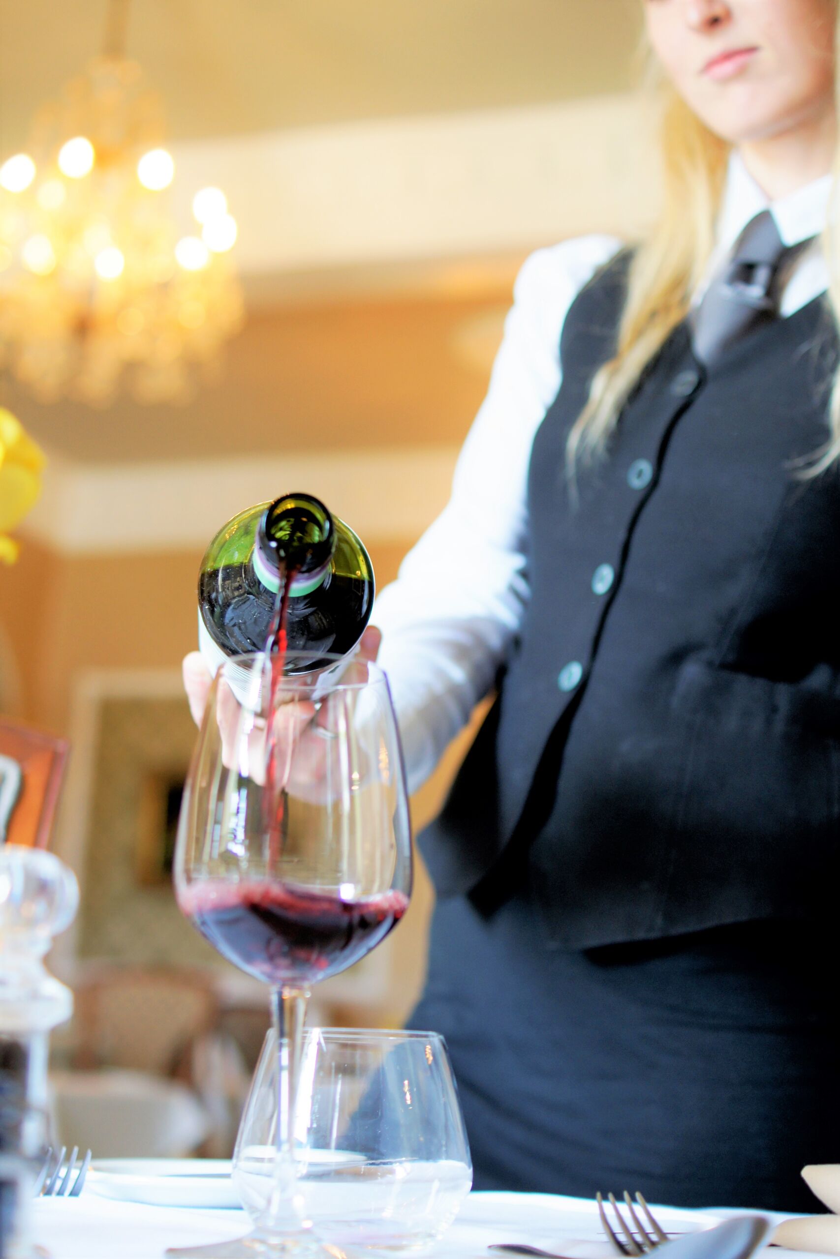 Waiter pouring red wine at The Bulkeley Hotel