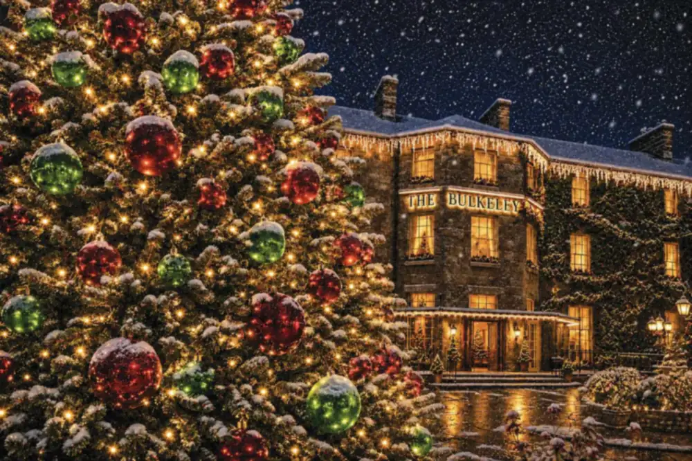 The Bulkeley Hotel in Beaumaris lit up for Christmas, with a decorated tree and falling snow