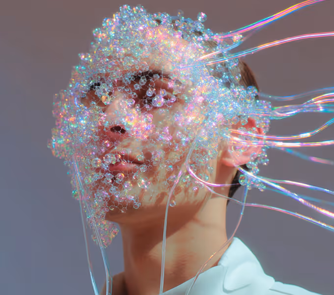 Portrait of a person with translucent iridescent bubbles and tubes covering their face.