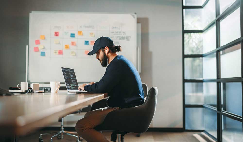 Sequel-Data-Systems-team-member-coding-at-a-workstation