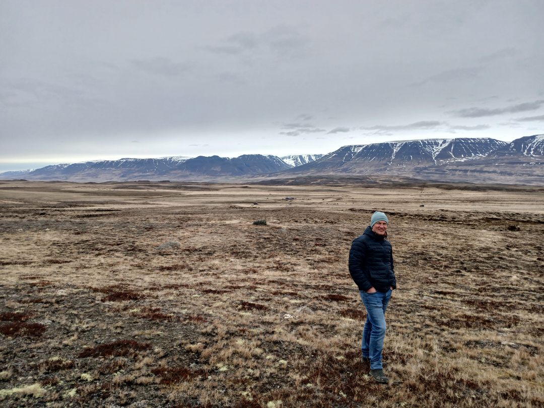 A person standing on bare, eroding land at Mælifellsá before planting