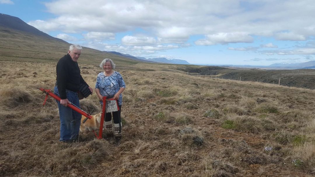 Our founder’s parents on open heathland in Iceland, holding tree-planting tools