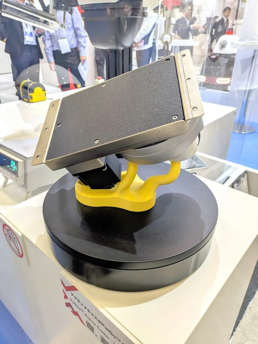The low-profile PalGo&trade; active caster and its display base (the yellow structure in the image)