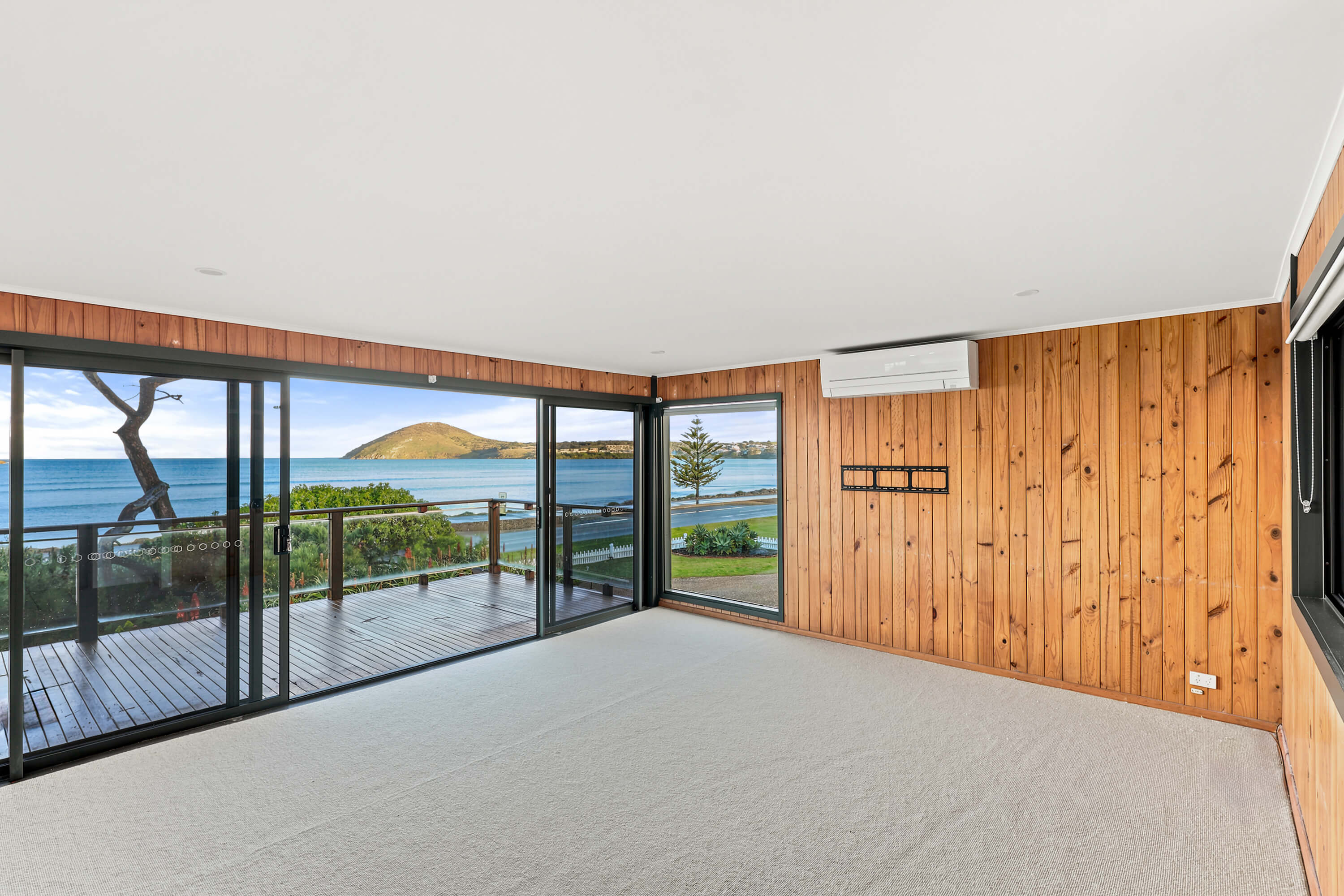 Timber-lined living room with sliding doors to the deck and views to The Bluff at Franklin Ave, Encounter Bay