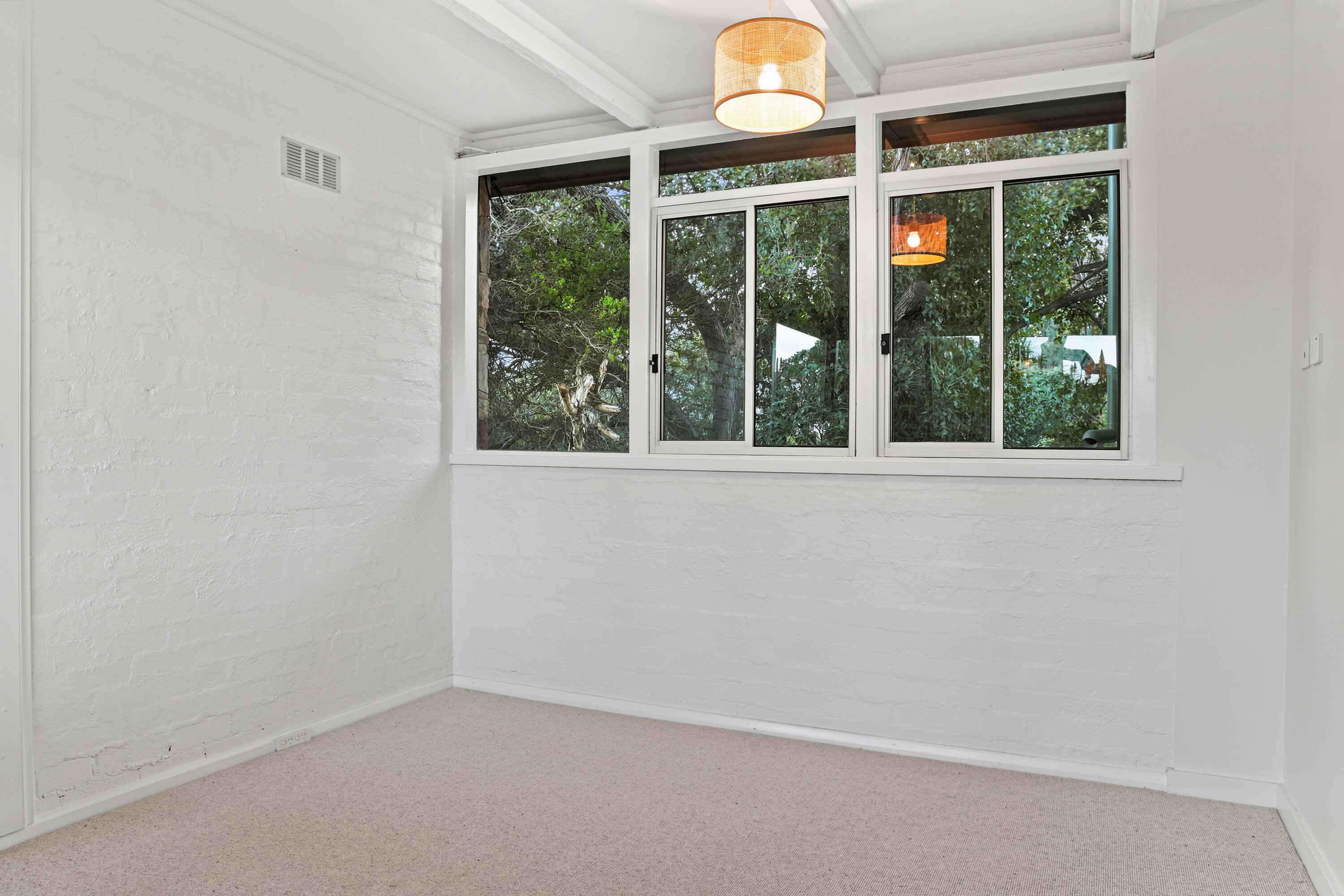 Painted brick bedroom with new sliding windows overlooking coastal trees at Franklin Ave, Encounter Bay