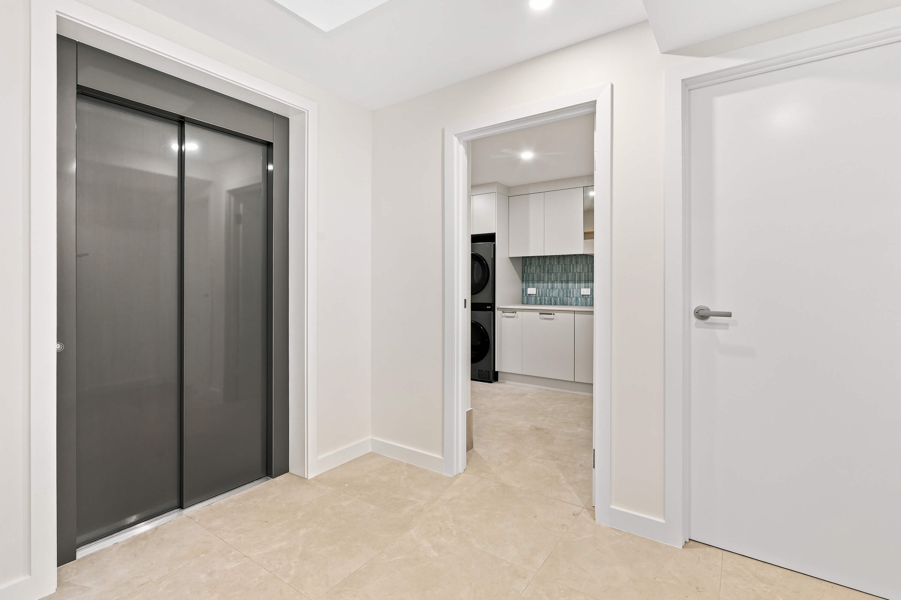 Hallway with residential lift and view through to the laundry at Franklin Ave, Encounter Bay