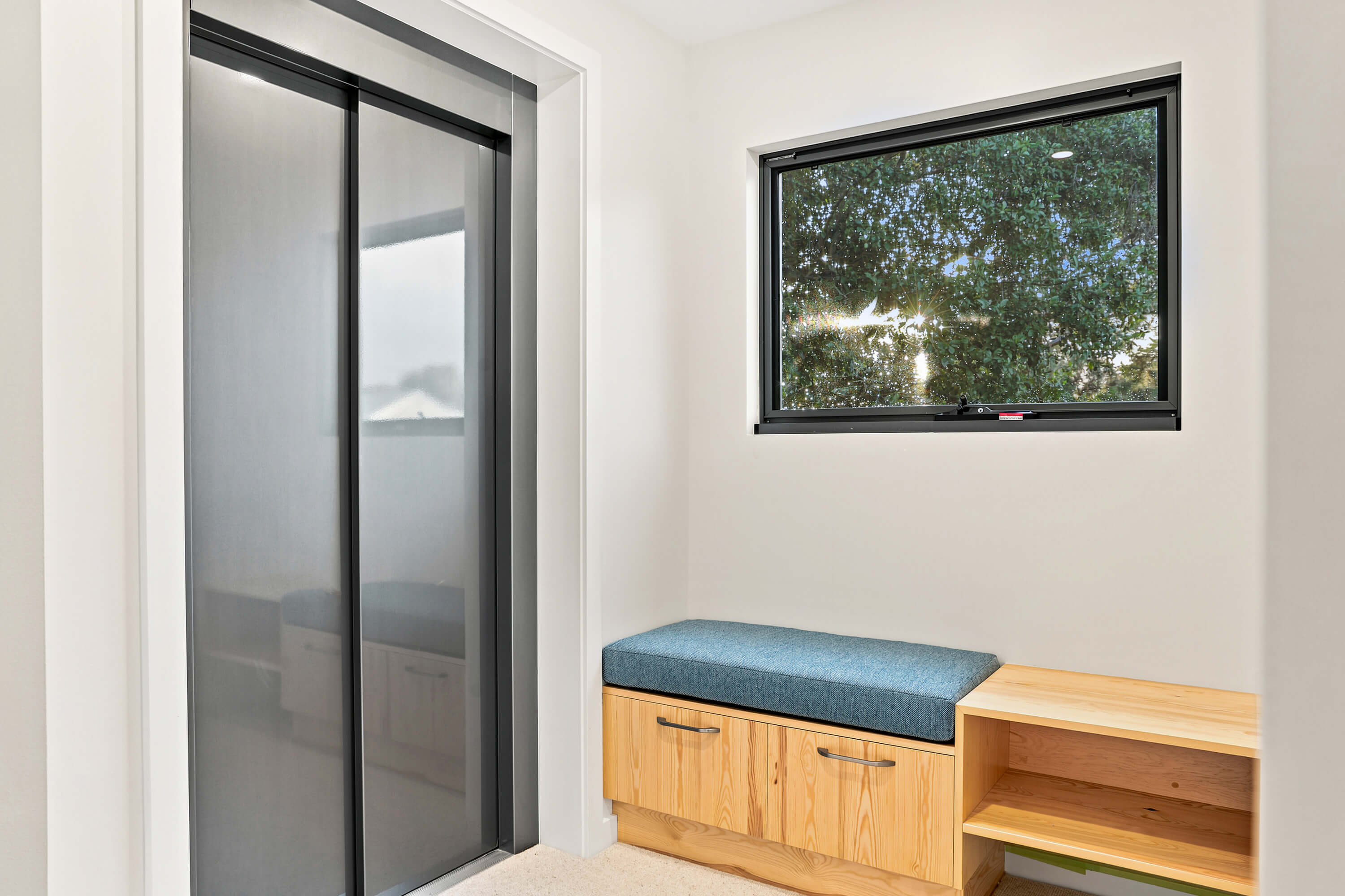 Mudroom bench seat with upholstered cushion beside the lift at Franklin Ave, Encounter Bay