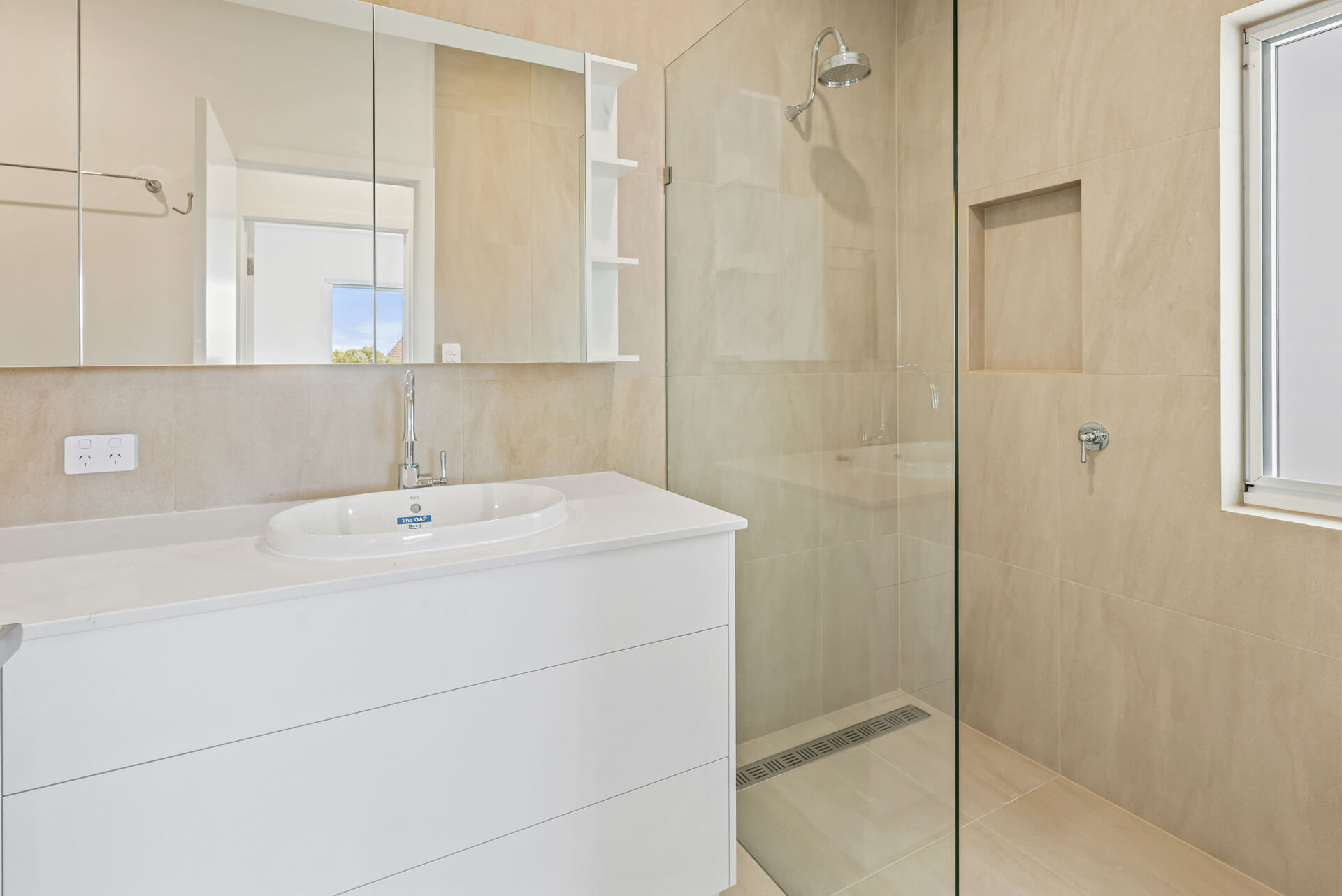 Ensuite with stone-look tiles, white vanity and walk-in shower at Victoria St, Victor Harbor