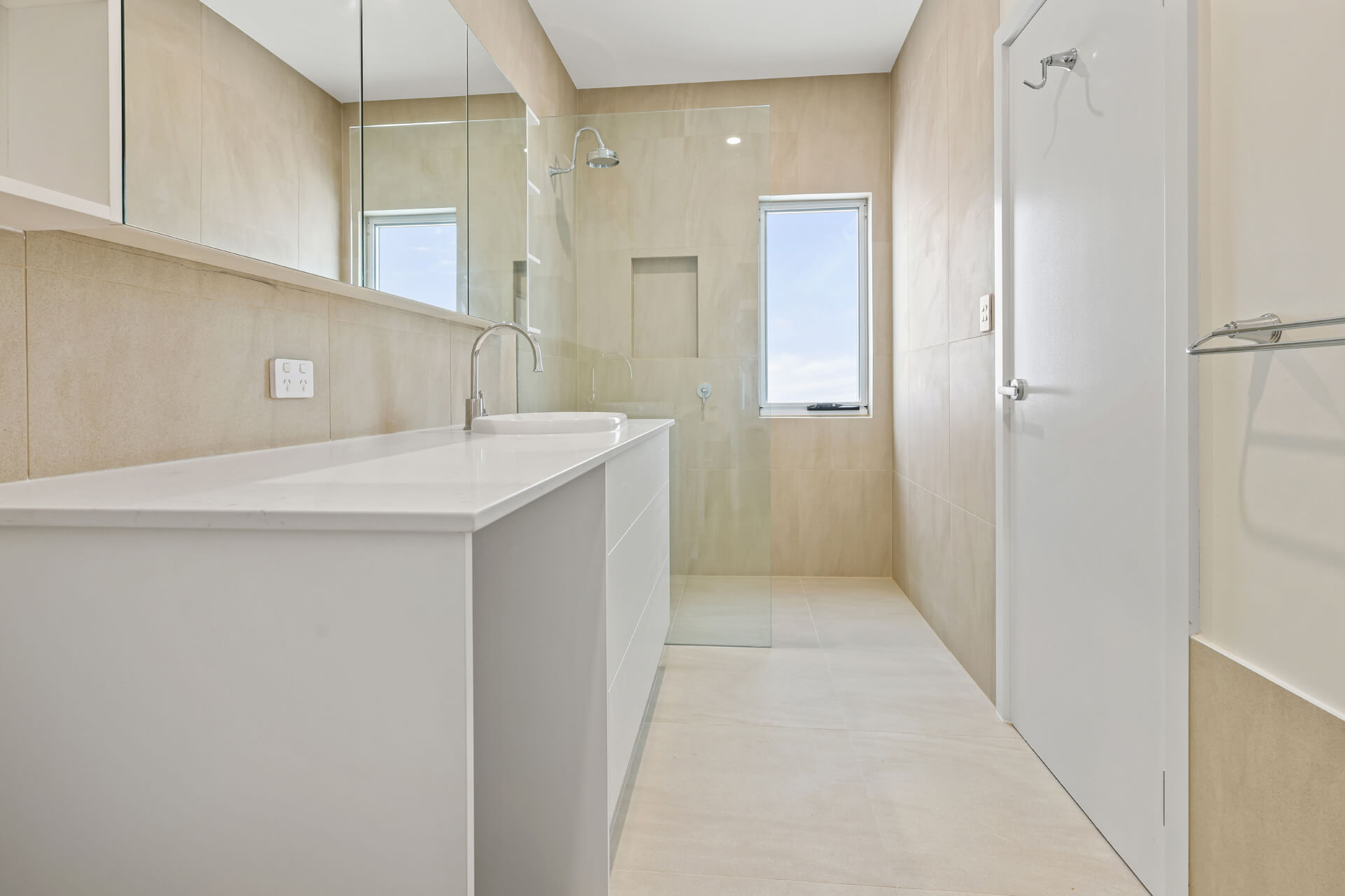 Ensuite with long white vanity, mirrored cabinets and walk-in shower at Victoria St, Victor Harbor