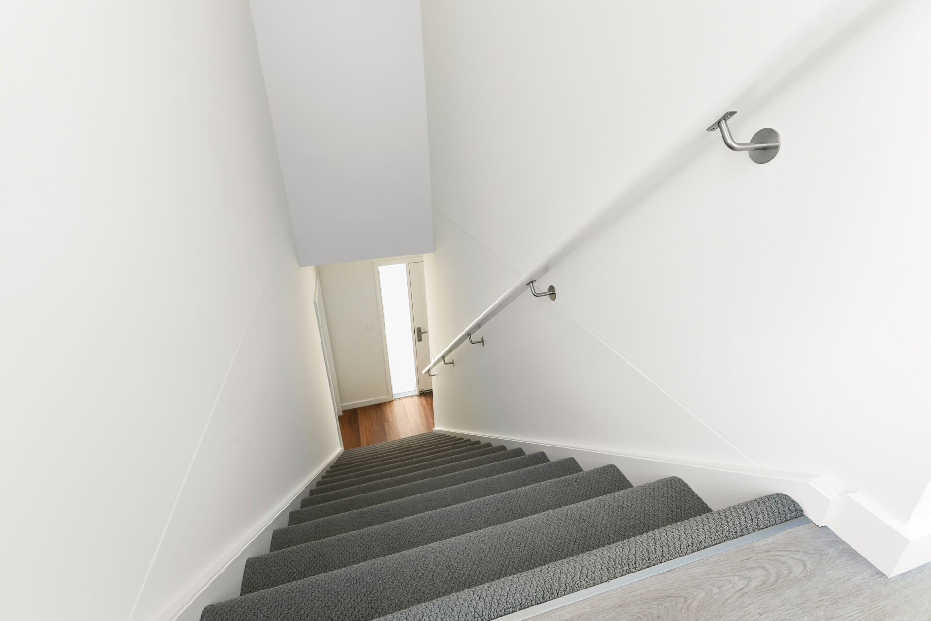 Staircase with grey carpet runner and stainless handrail at Victoria St, Victor Harbor