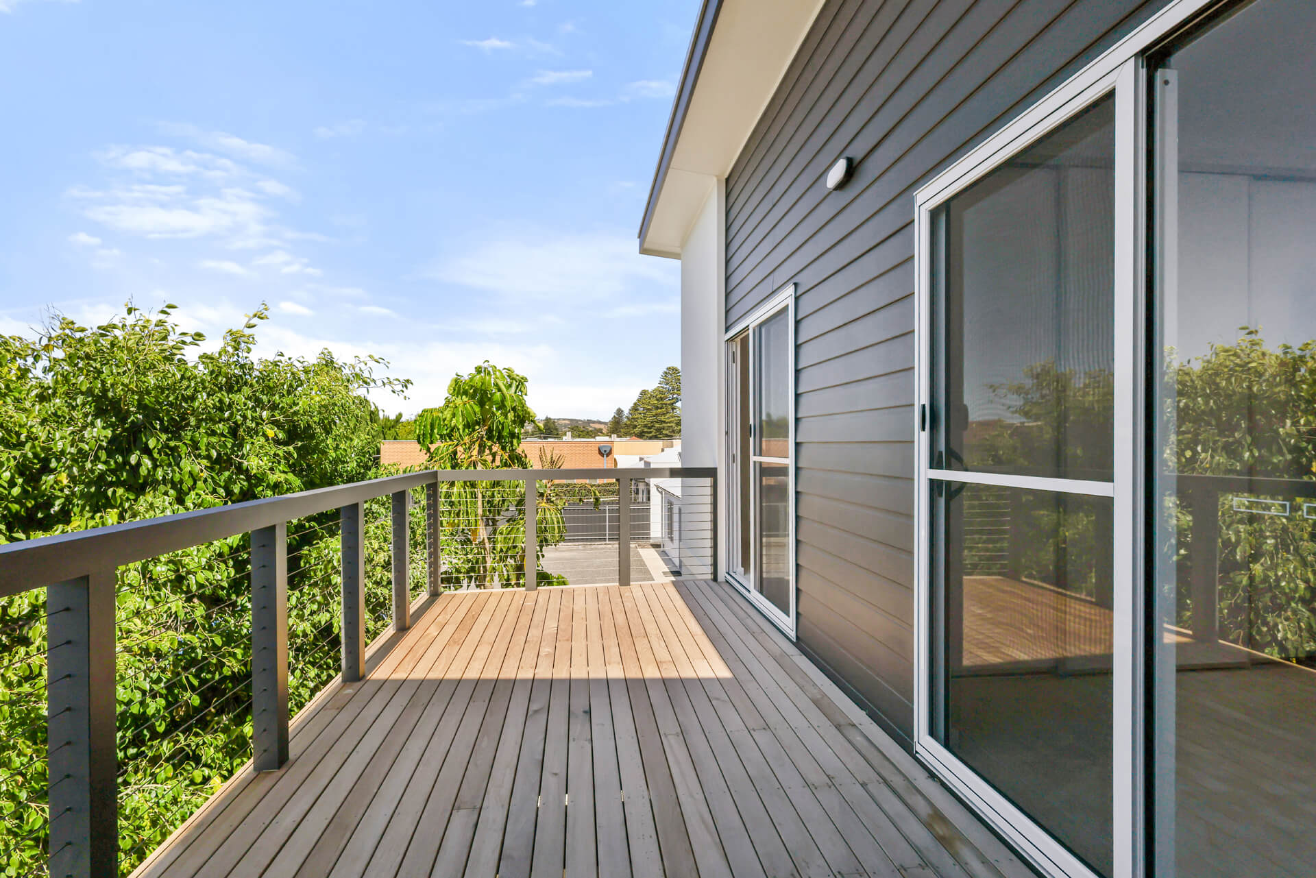 Timber deck and wire balustrade wrapping the upper storey at Victoria St, Victor Harbor