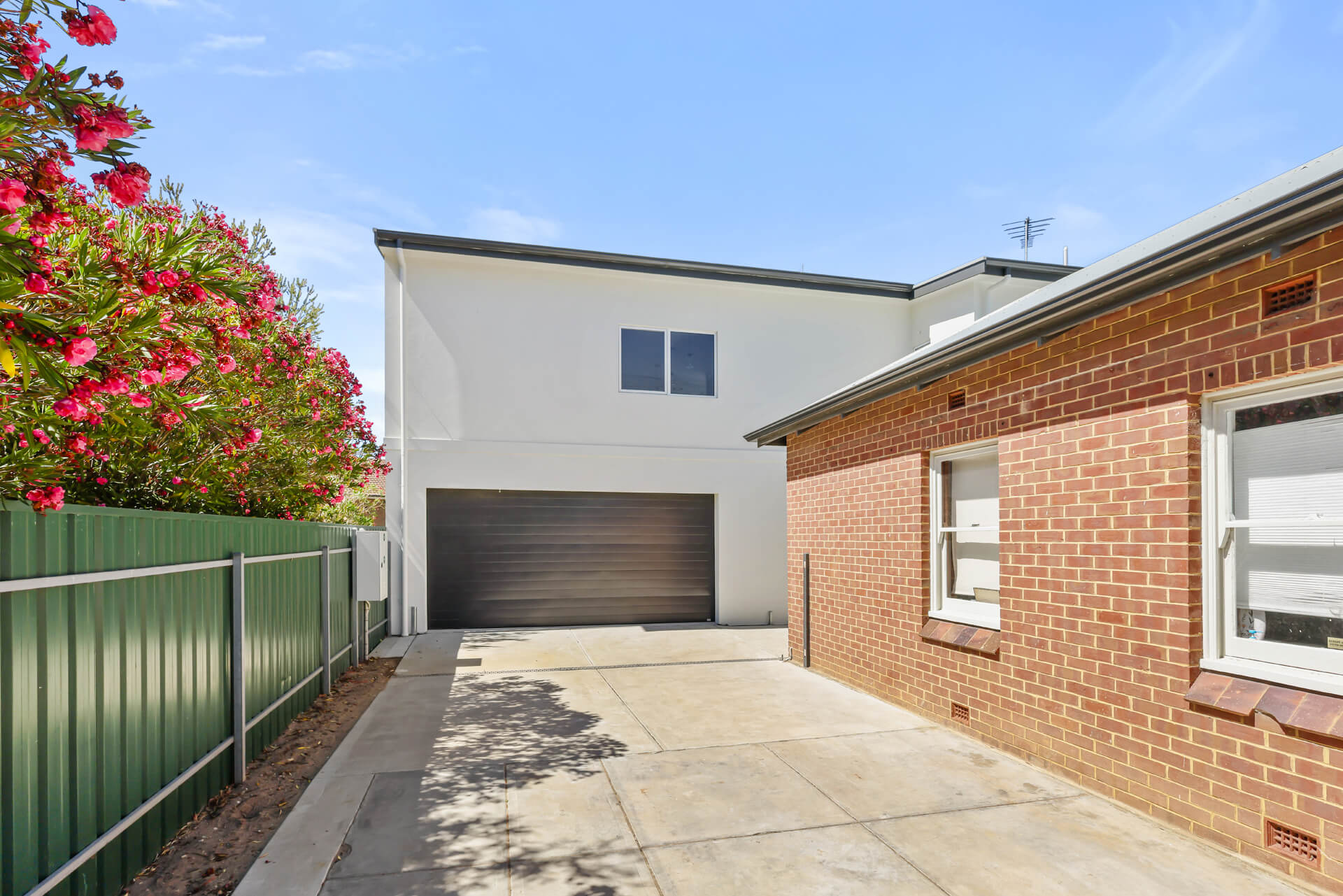 Two storey addition rising behind the original brick cottage at Victoria St, Victor Harbor