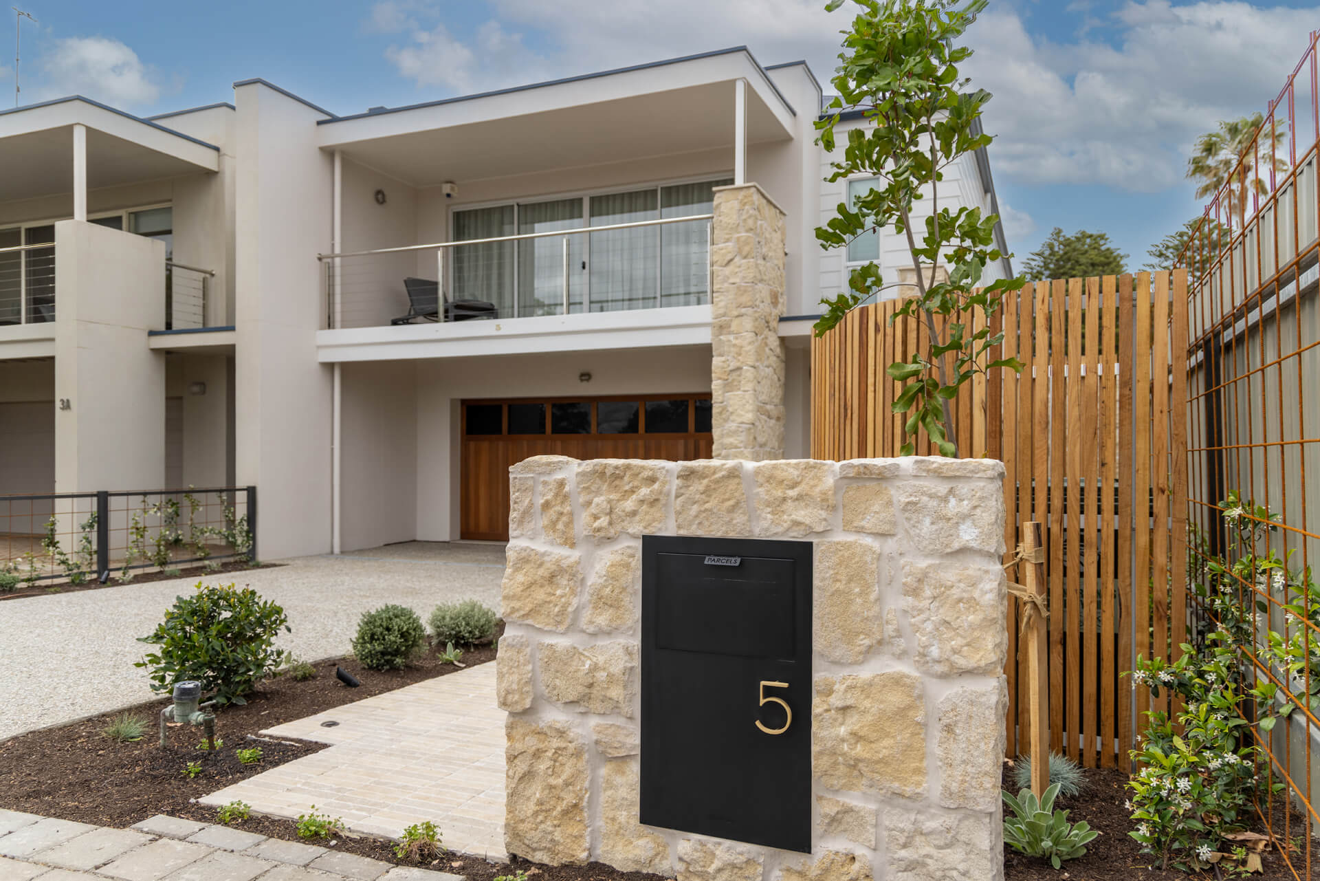 Front facade of Henry St, Port Elliot, with limestone letterbox pier numbered 5 and timber batten fence
