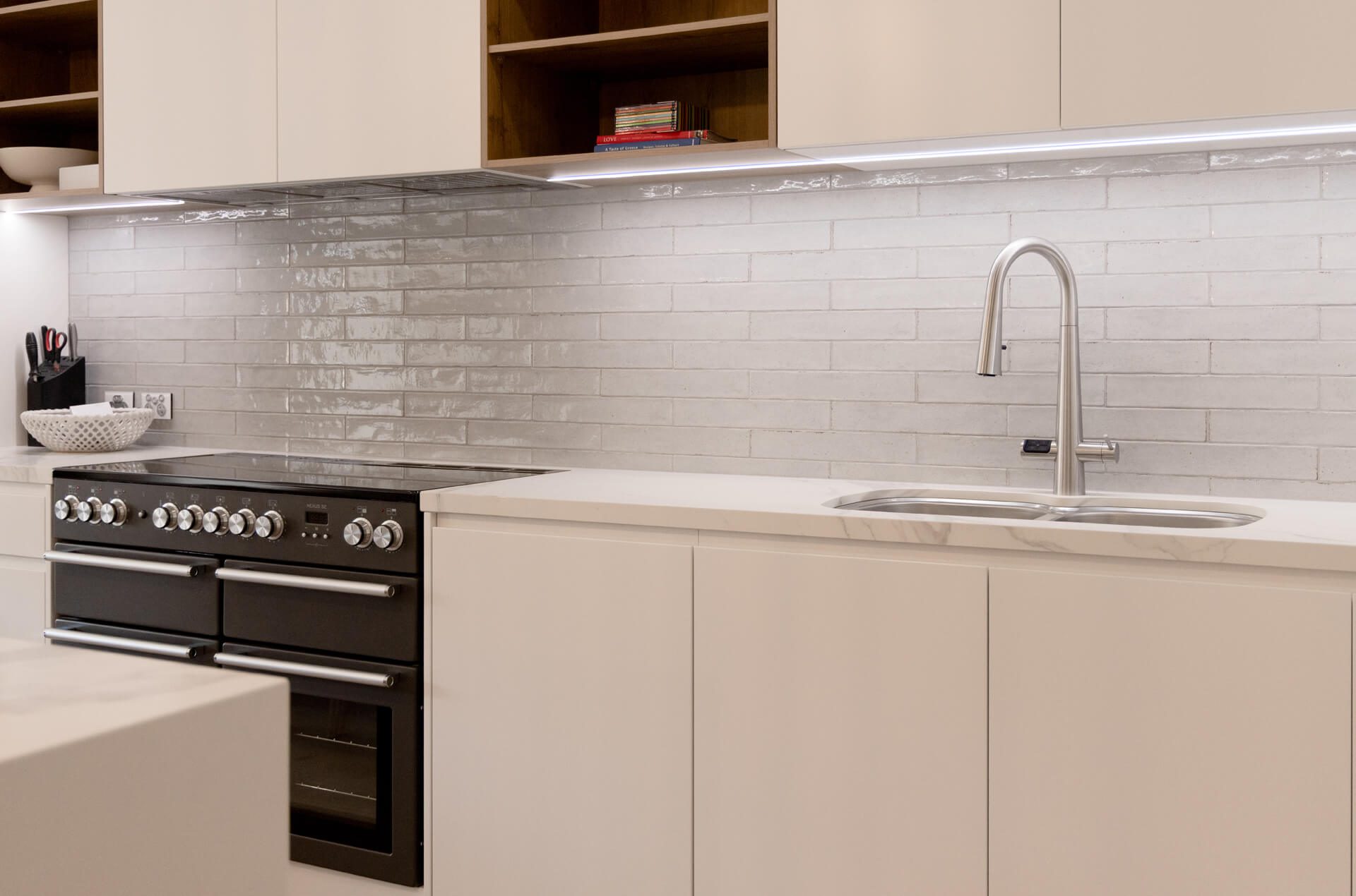 White shaker kitchen with black freestanding range cooker and handmade subway tile splashback at Henry St, Port Elliot