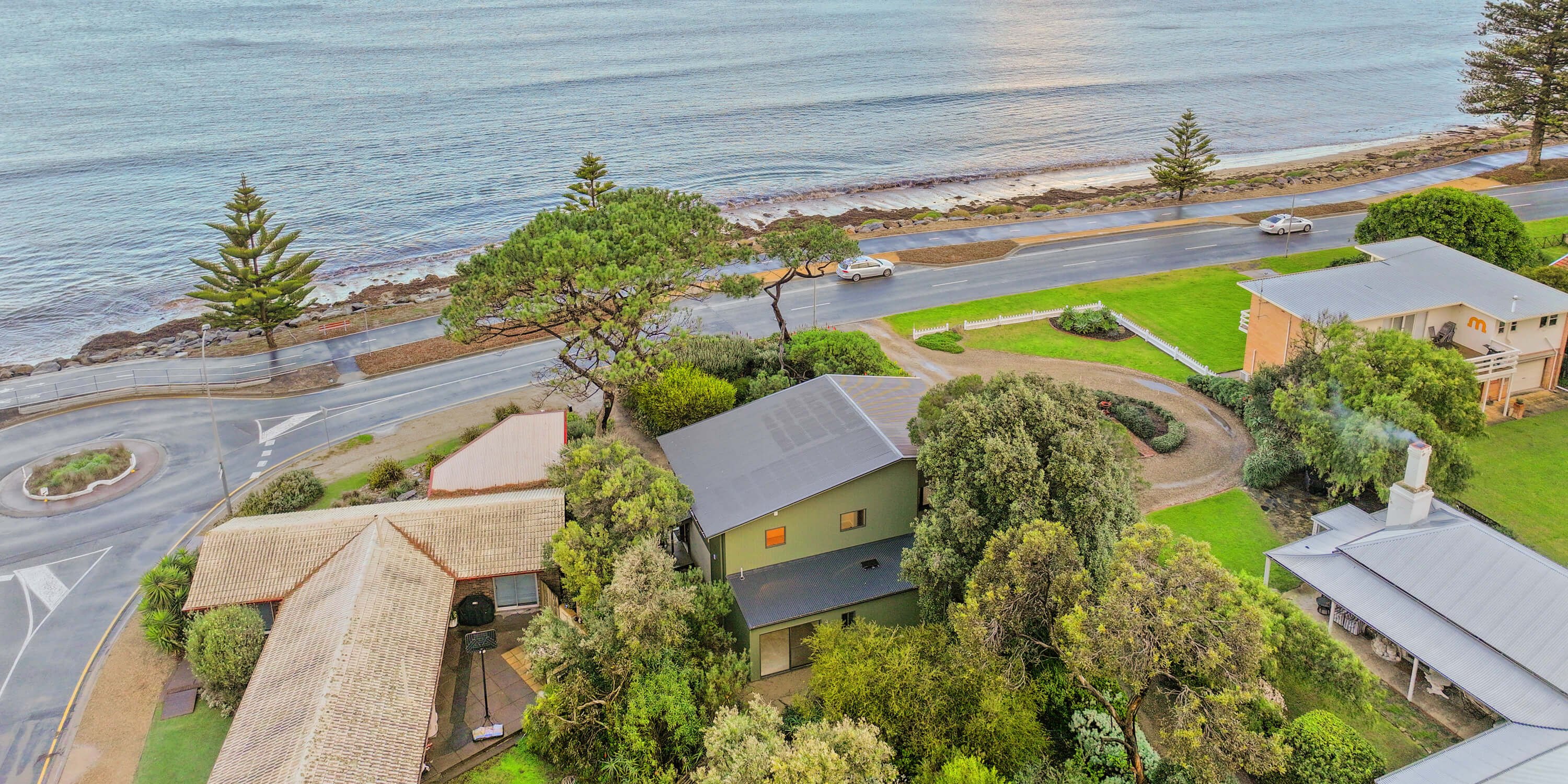 Aerial of the completed Franklin Parade renovation at Encounter Bay, the two storey house between the beachfront road and the sea