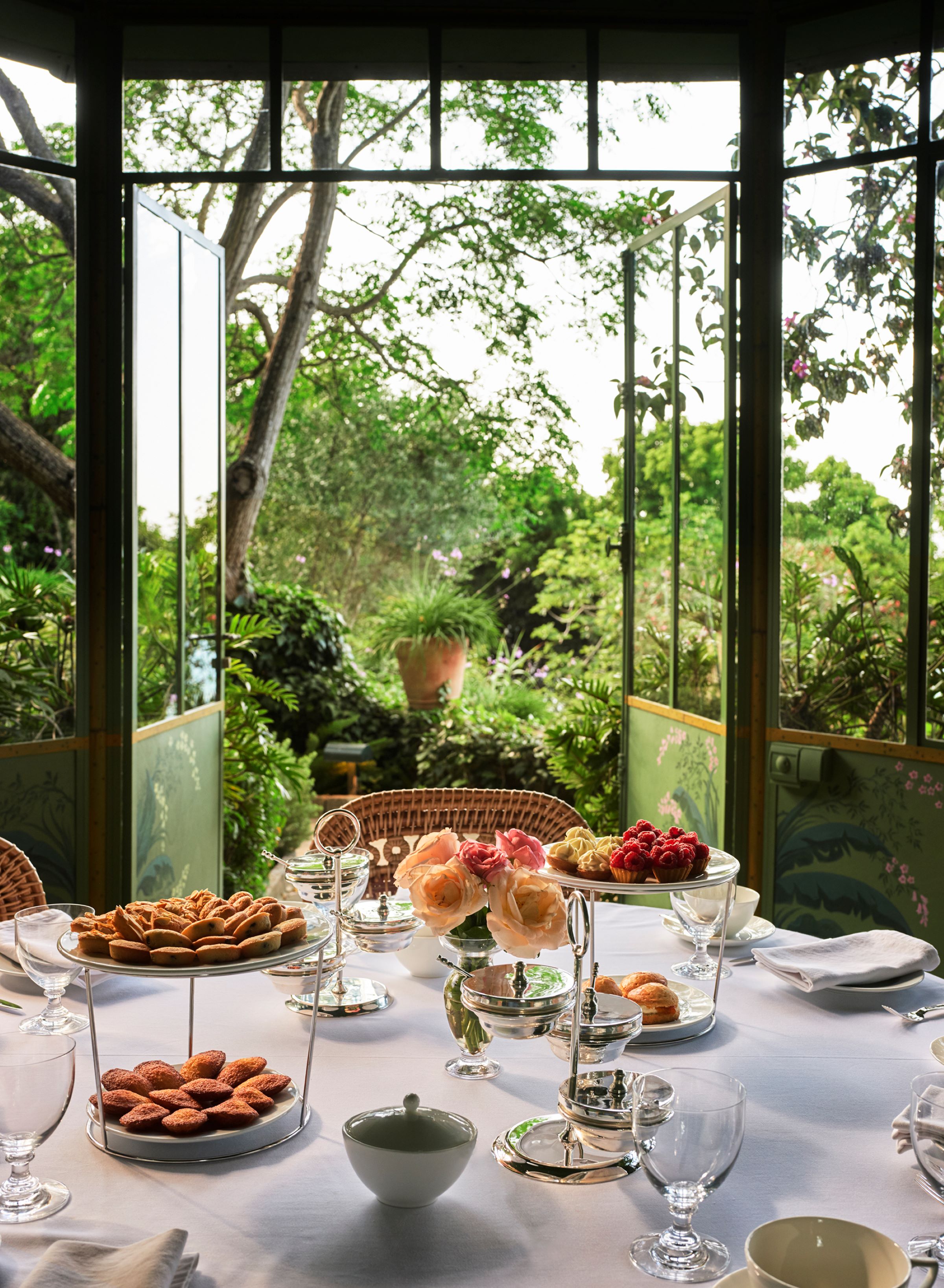 Afternoon tea with pastries and sandwiches laid out in a garden pavilion at Villa Mabrouka