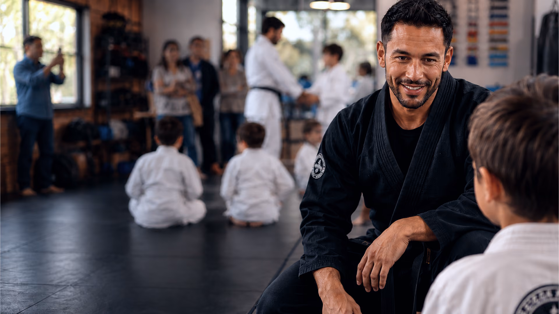 Martial arts instructor working with a young student during class
