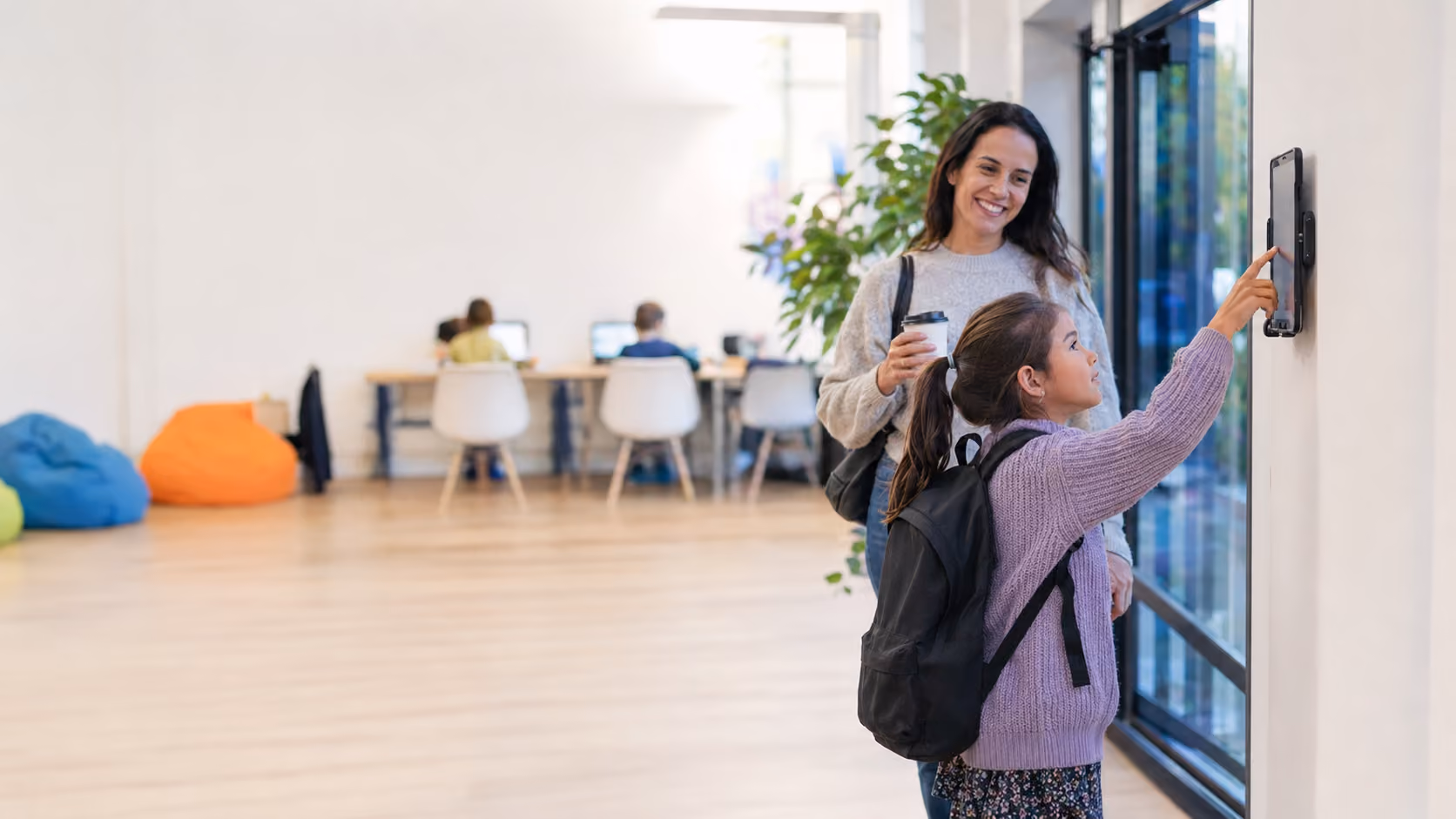 Martial arts instructor with a young student during class check-in