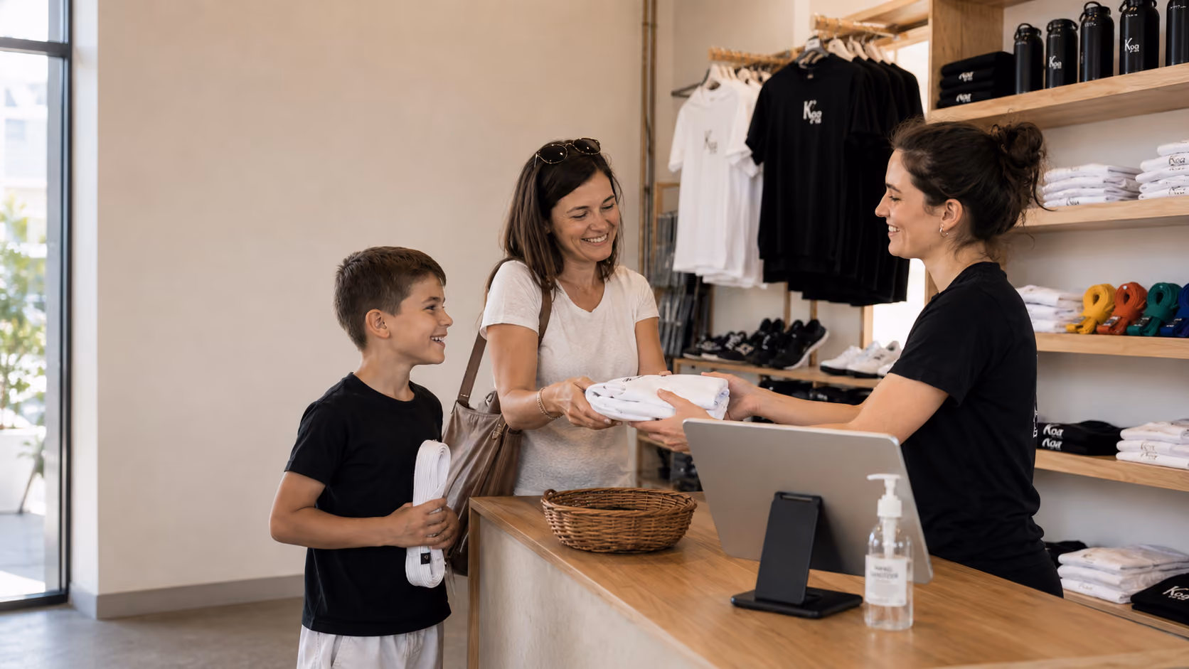 Martial arts instructor with a young student during class check-in