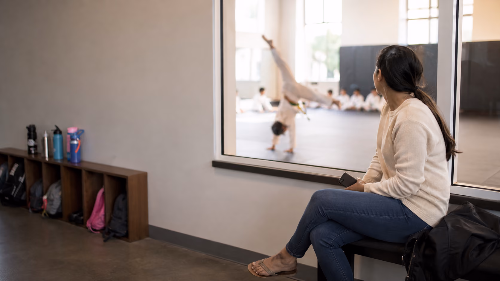 Martial arts instructor with a young student during class check-in
