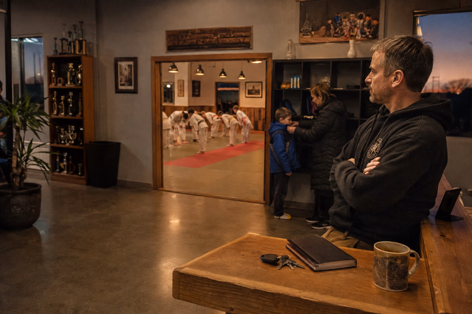 Studio owner and instructors on the mat at a busy martial arts school