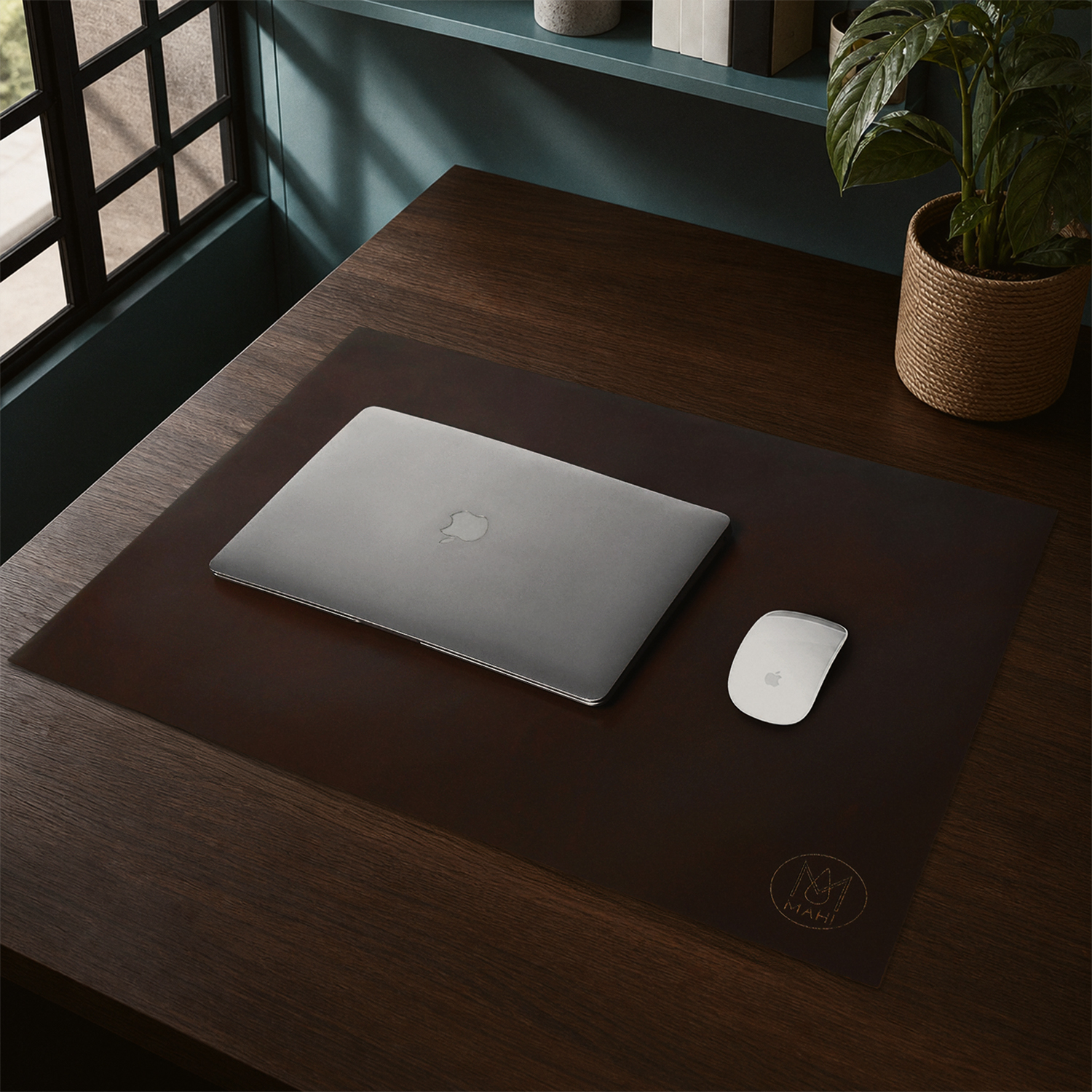 Brown leather desk mat with a laptop and mouse in a styled home office setting