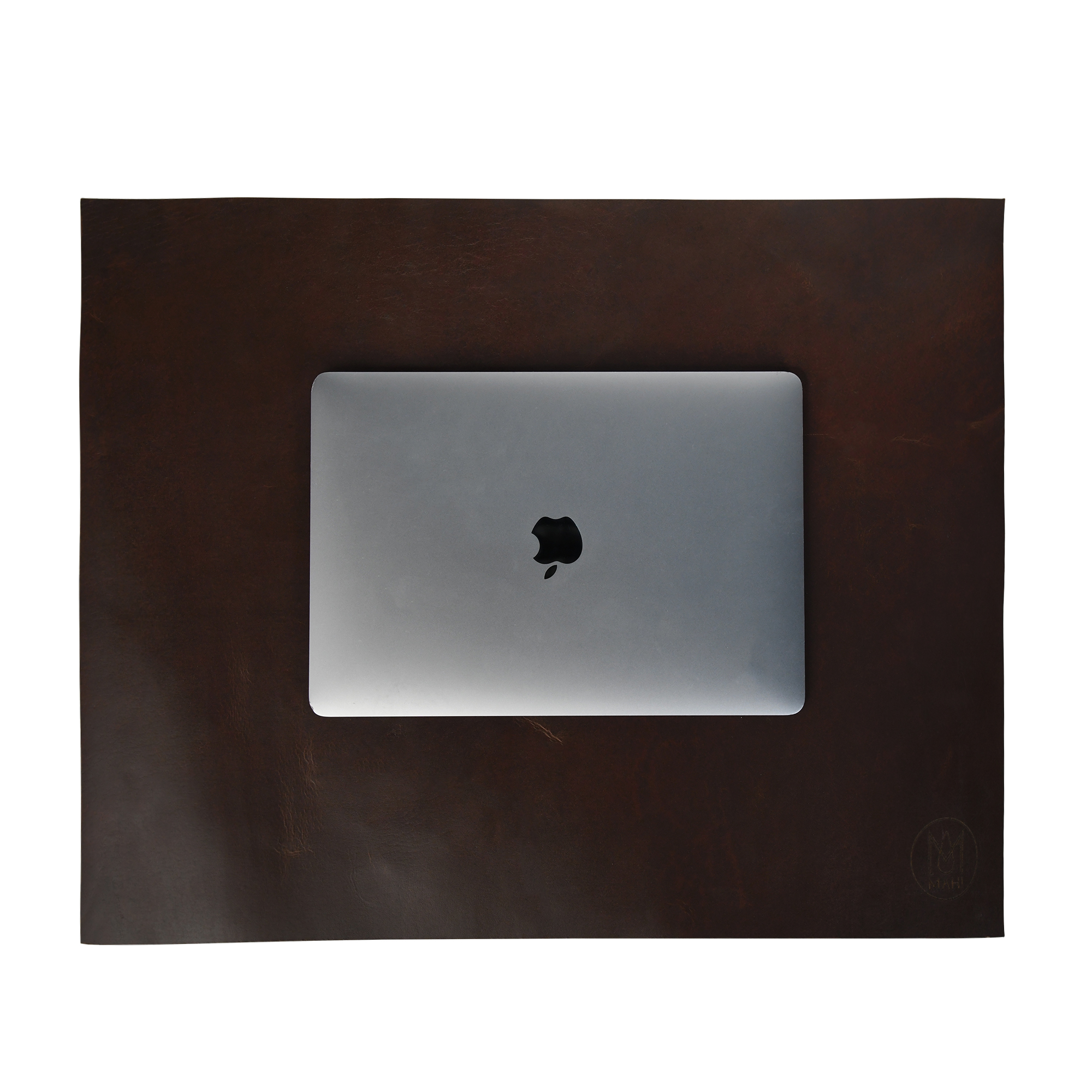 Top-down product image of a brown leather desk mat with a silver laptop before retouching