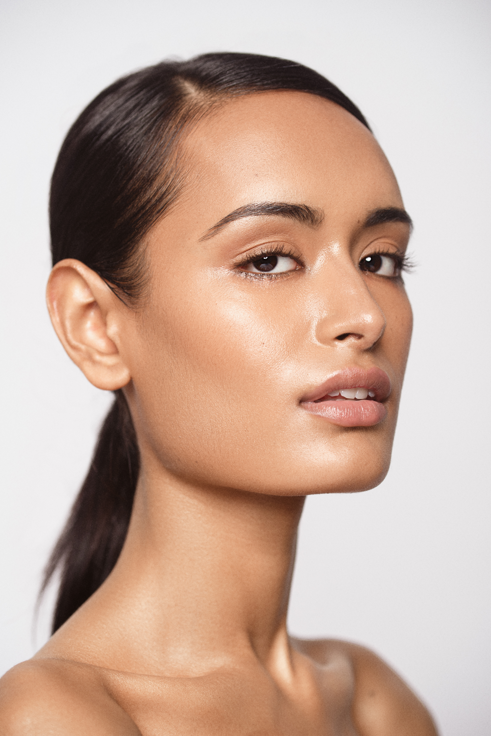 Final beauty portrait with clean natural skin texture, balanced tones and soft luminous makeup