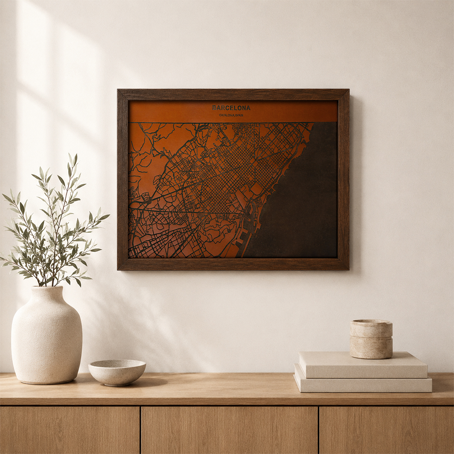 Lifestyle mockup of a framed Barcelona map artwork displayed above a wooden console table