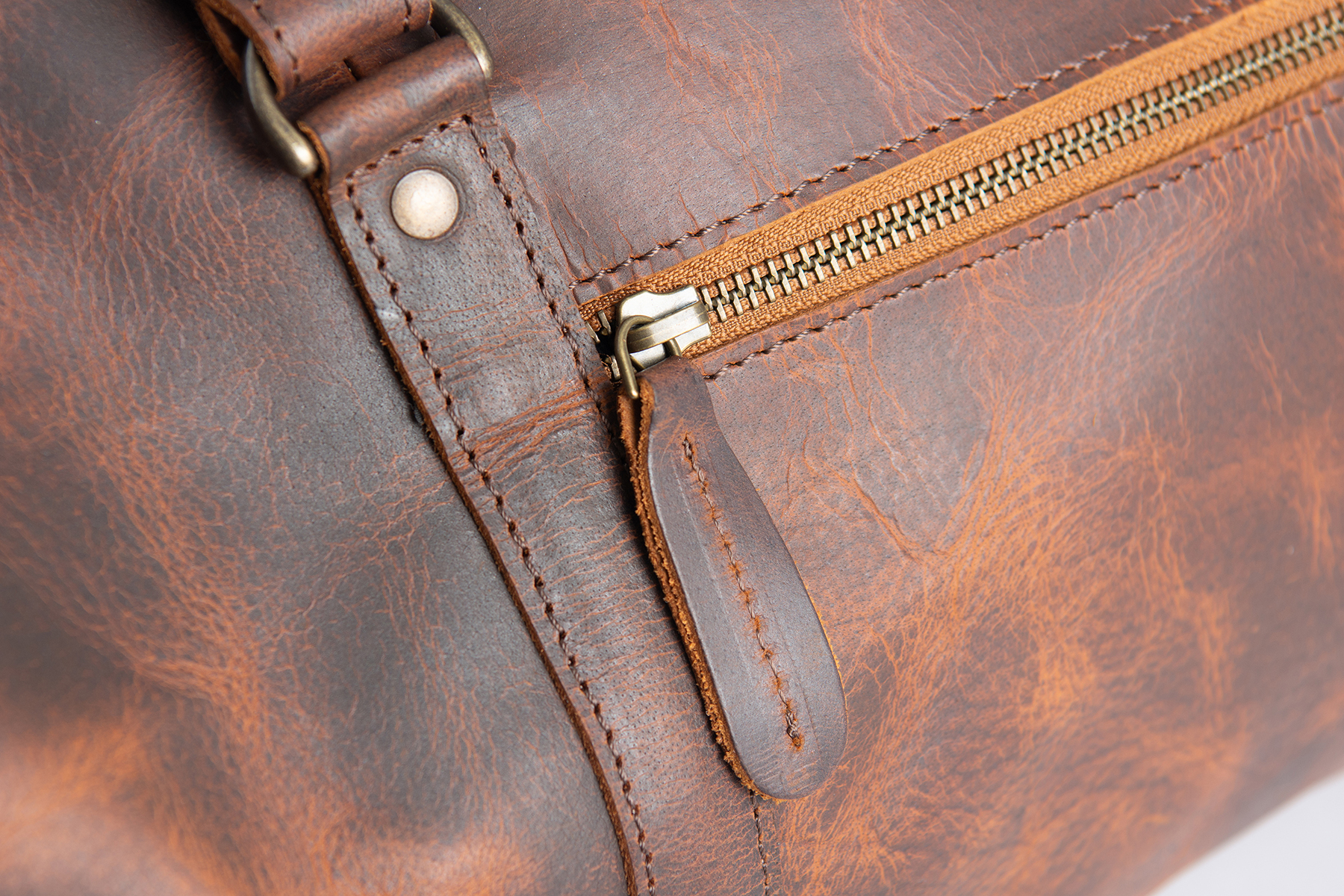 Close-up of a leather bag zipper and metal hardware before retouching