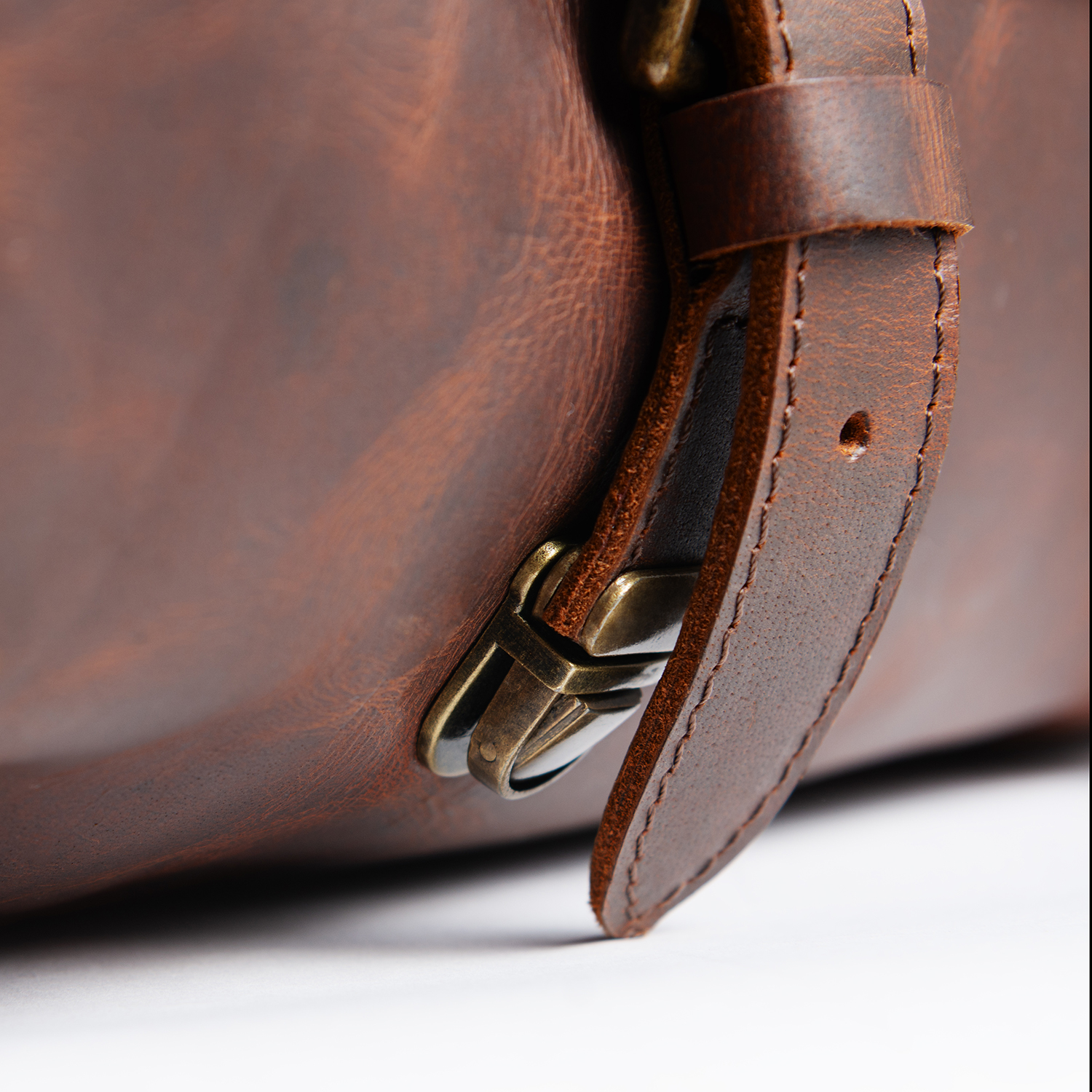 Close-up of a leather strap, buckle and detailed waxy leather texture