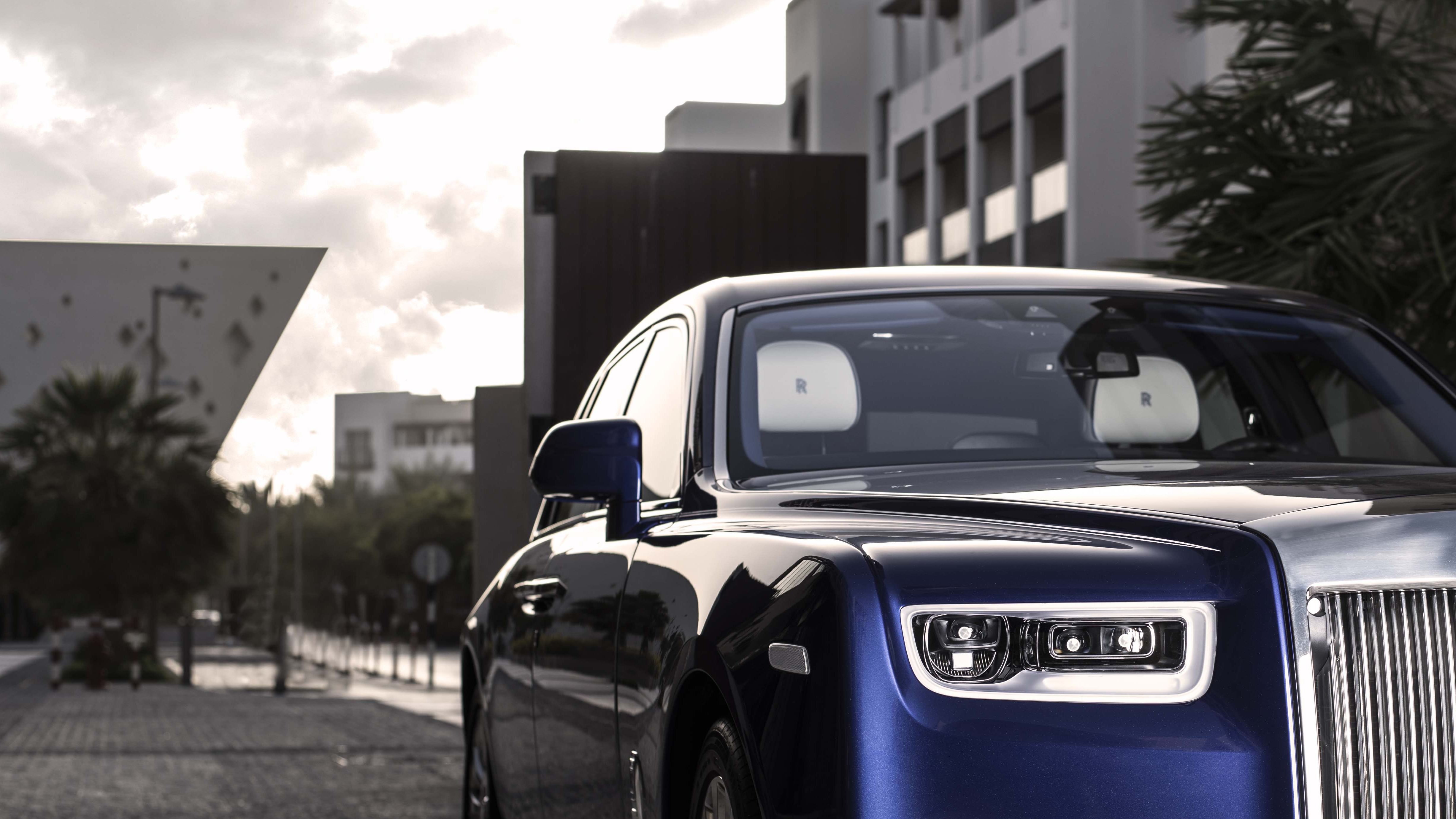 Close-up of the front grille of a blue Rolls-Royce Phantom.