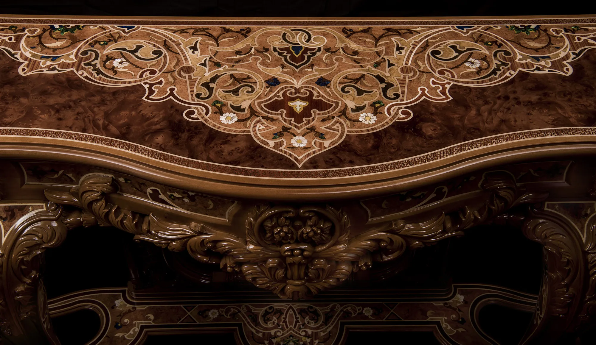 A close up of a traditional luxury wood inlay, custom console made of mahogany and a wood-pearl top. Infused with mother of pearl. On a black background. 