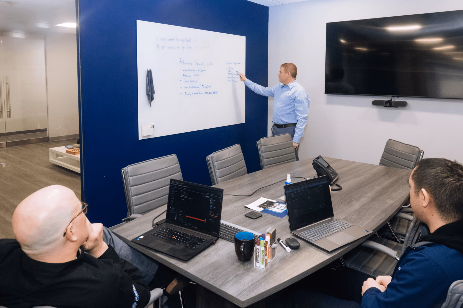 Shartega IT team mapping out a technology plan on a whiteboard