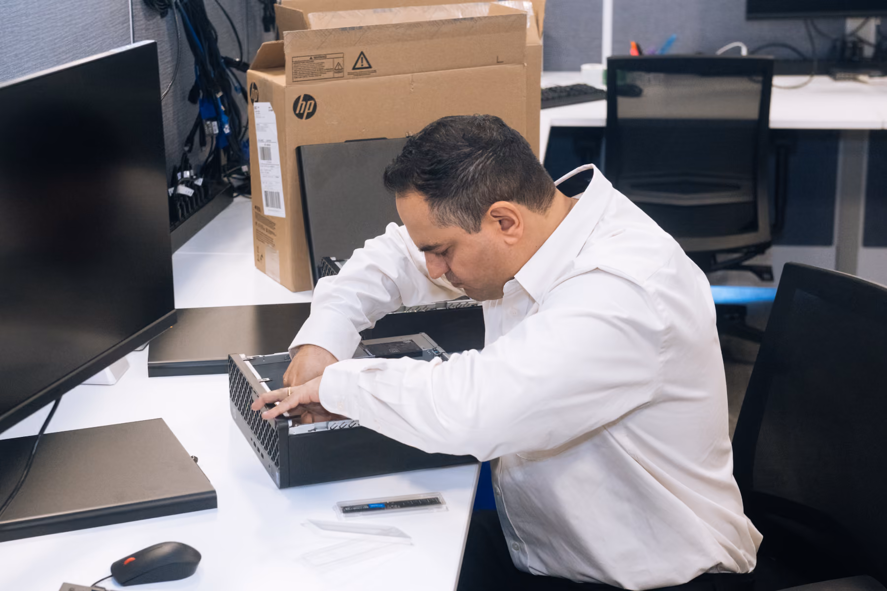 Shartega IT technician resolving a support ticket at a workstation