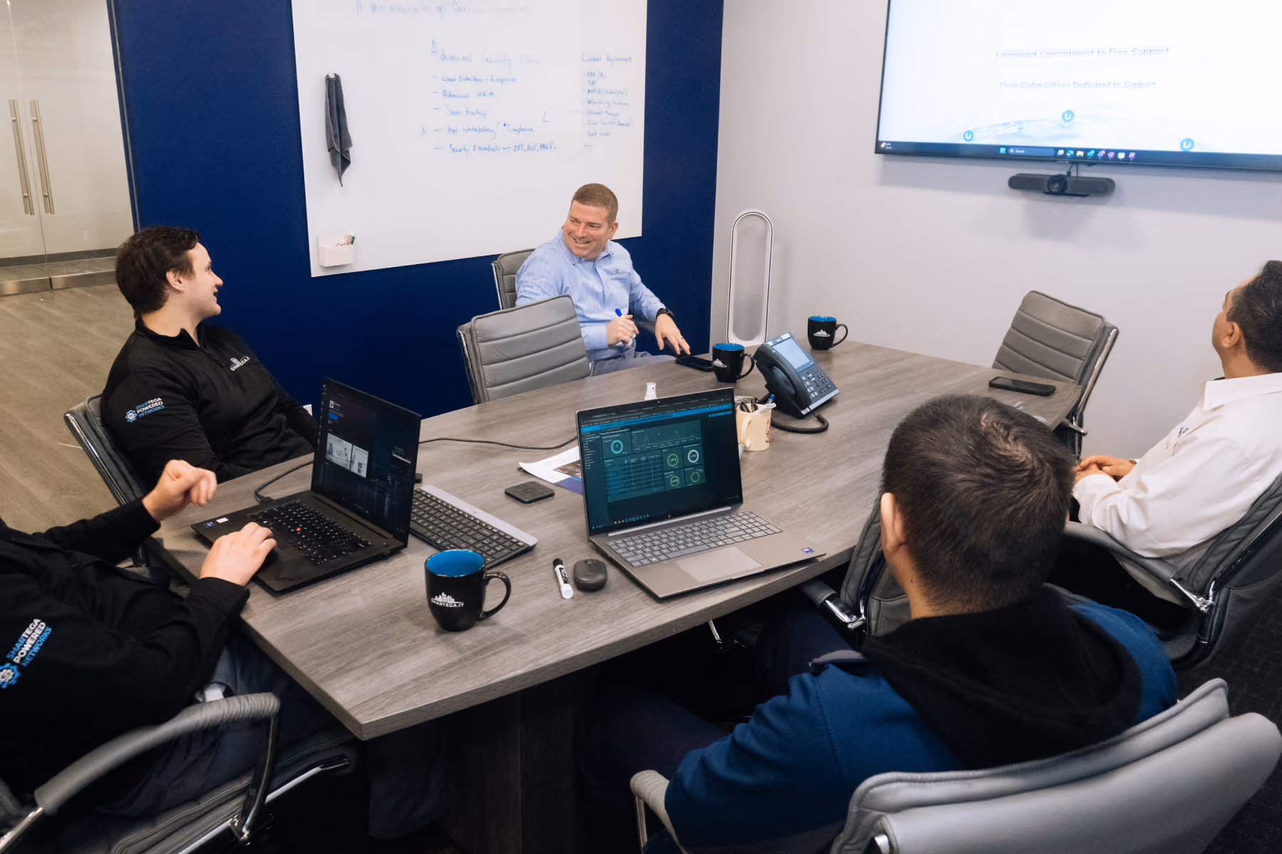 Shartega IT engineers collaborating at a workstation