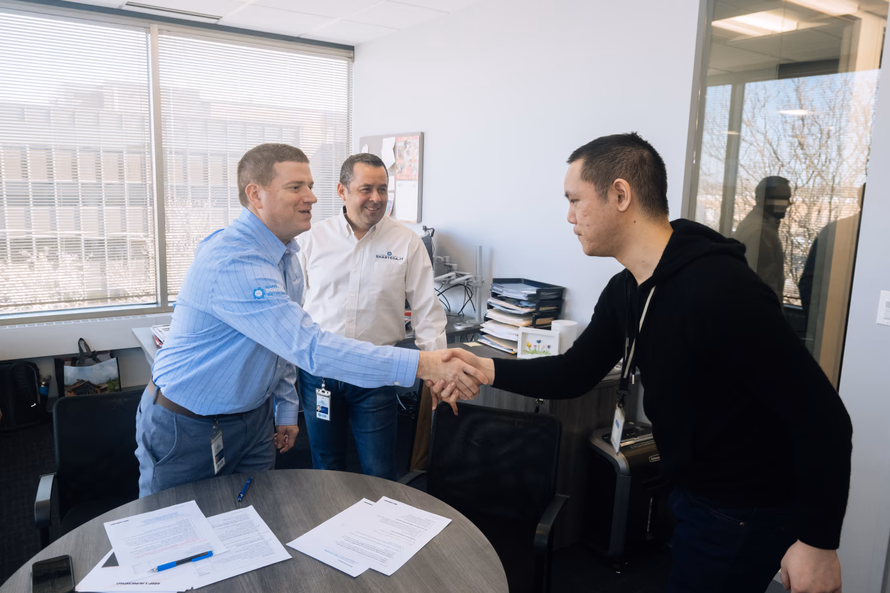 Shartega IT team member shaking hands with a client