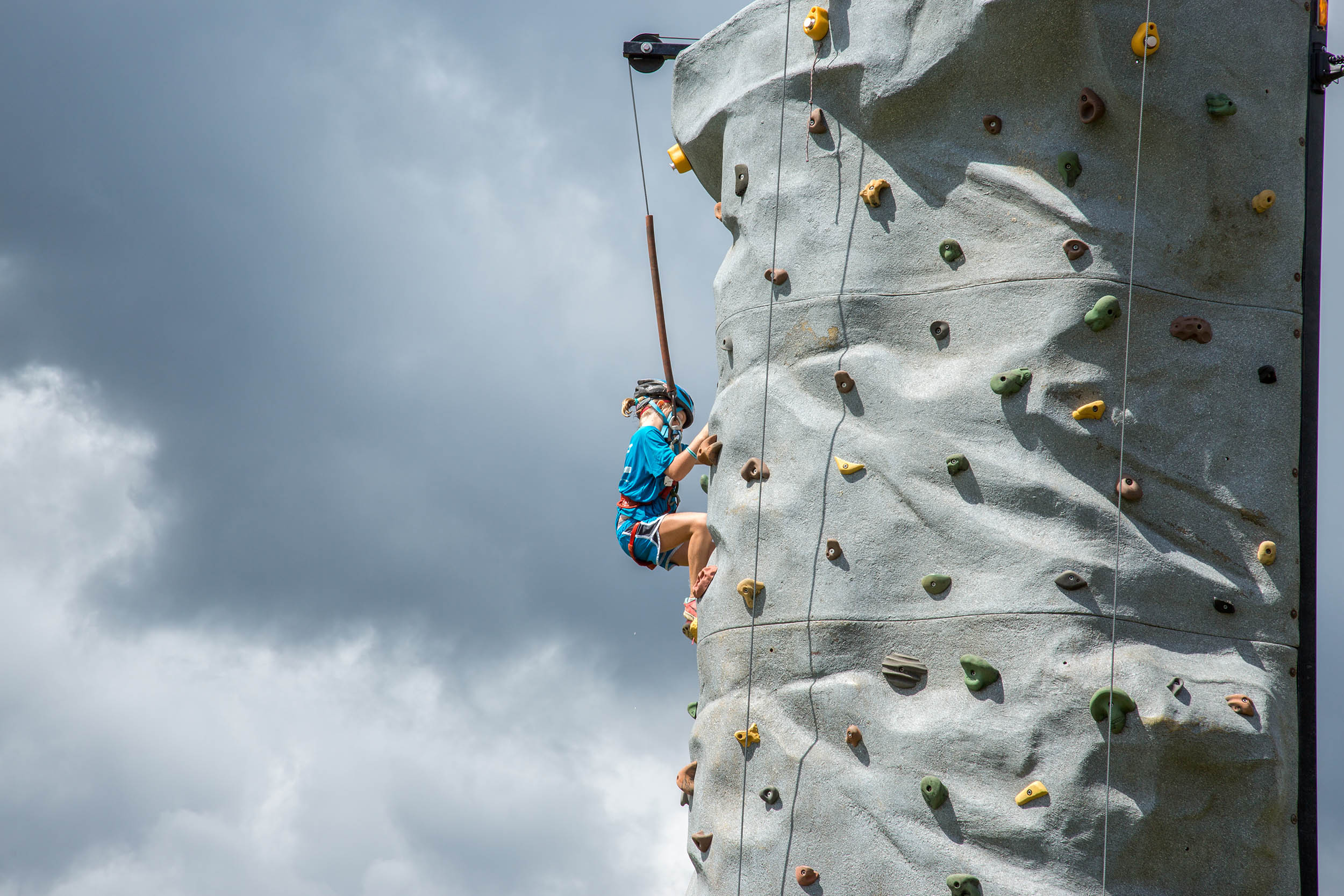 The 24ft mobile climbing wall towering against storm clouds