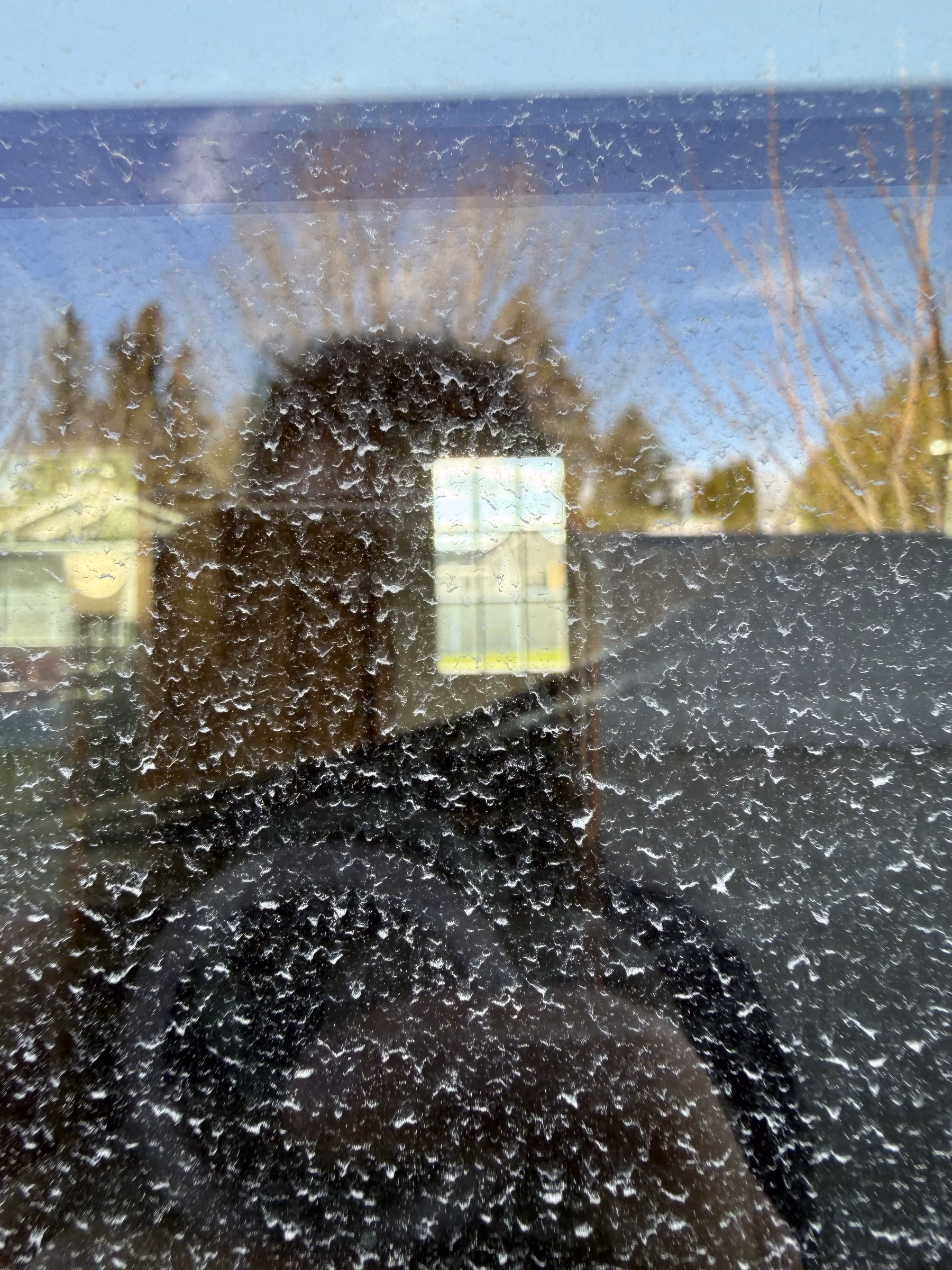 Hard water spotting on a Southeast Idaho window before Wake removes it