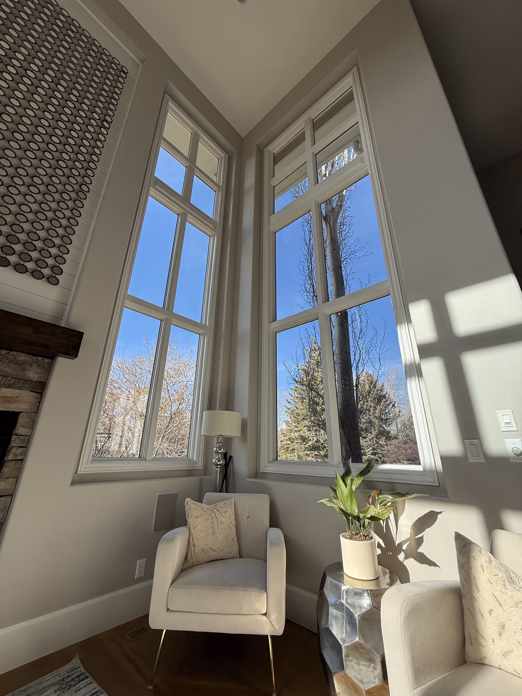 Cleaning tall south-facing living room glass in Victor, Idaho